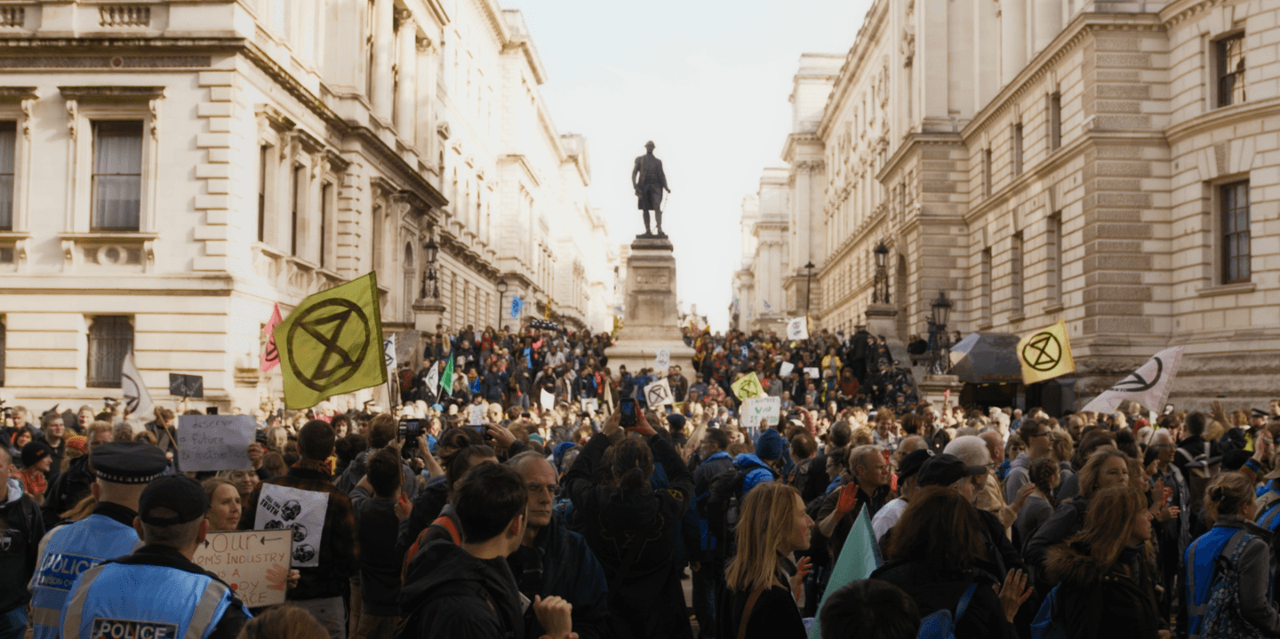 XR protesters gathered in front of statue